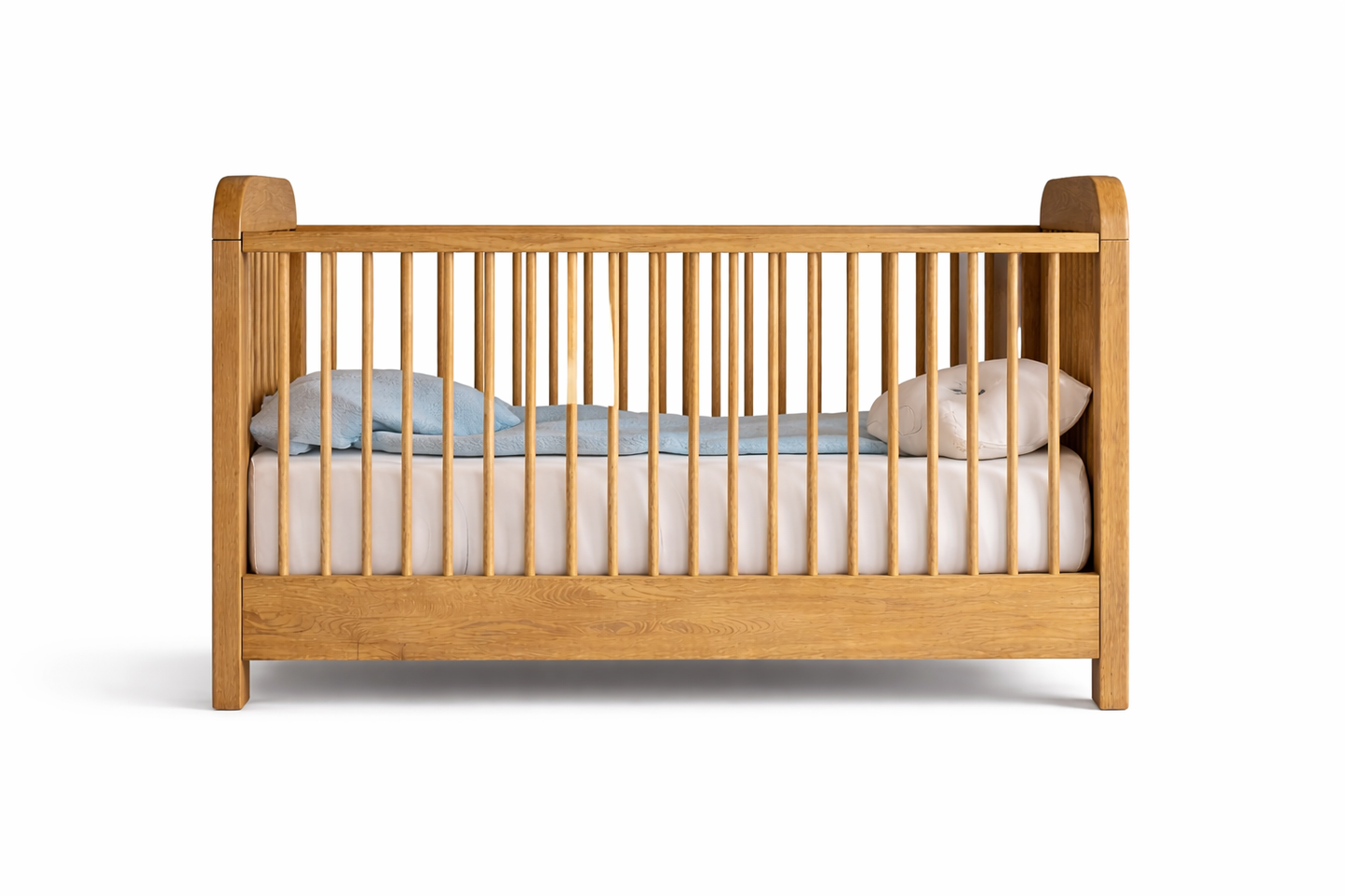 Wooden crib with bedding on a white background