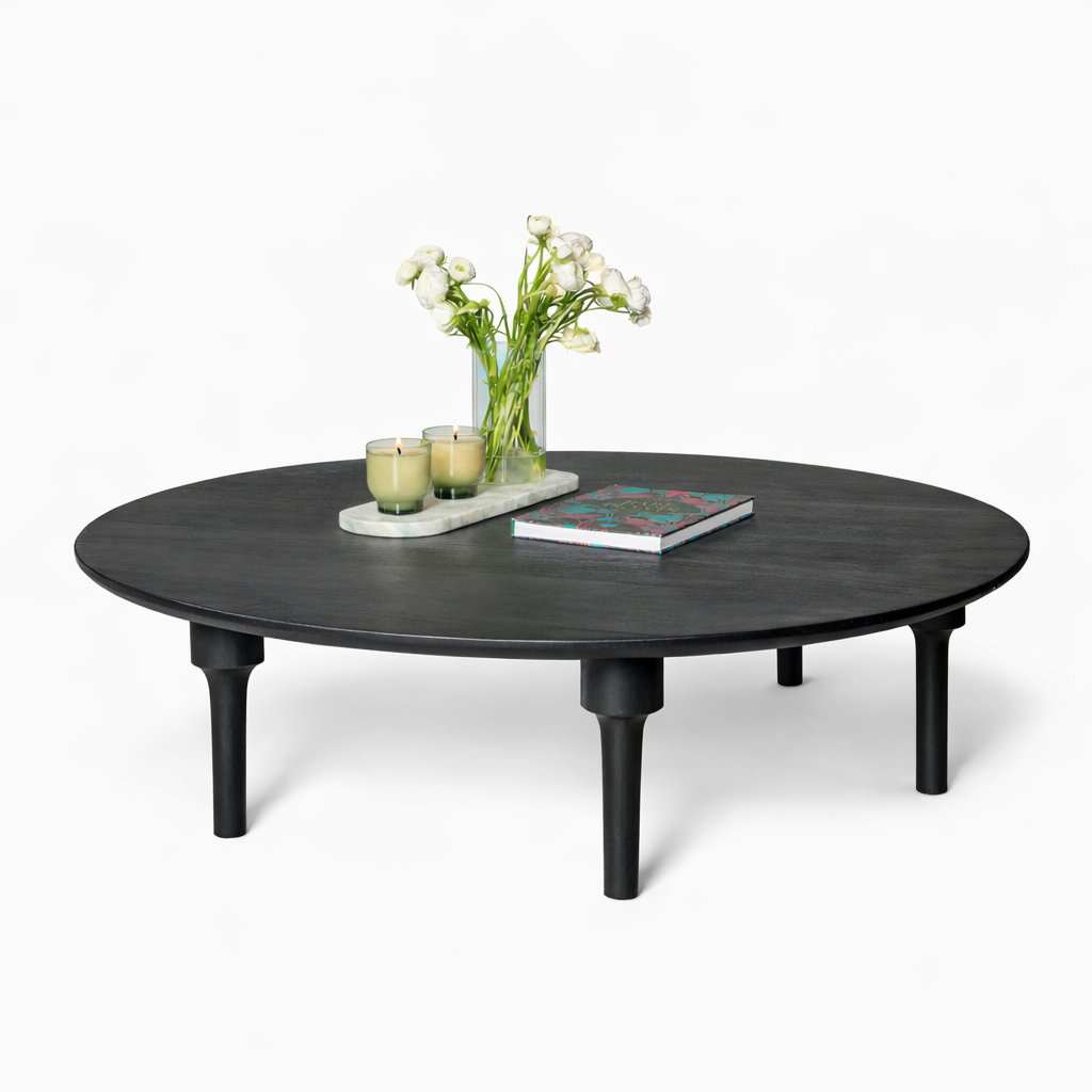 Luxury Round black coffee table with a vase of flowers and books on a white background