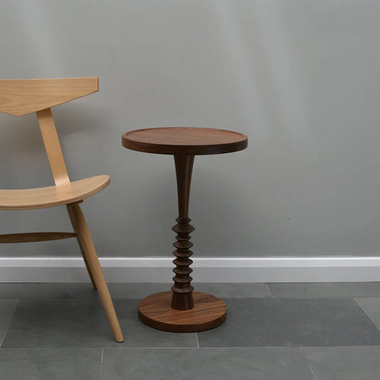 Luxury Wooden side table and chair against a gray wall