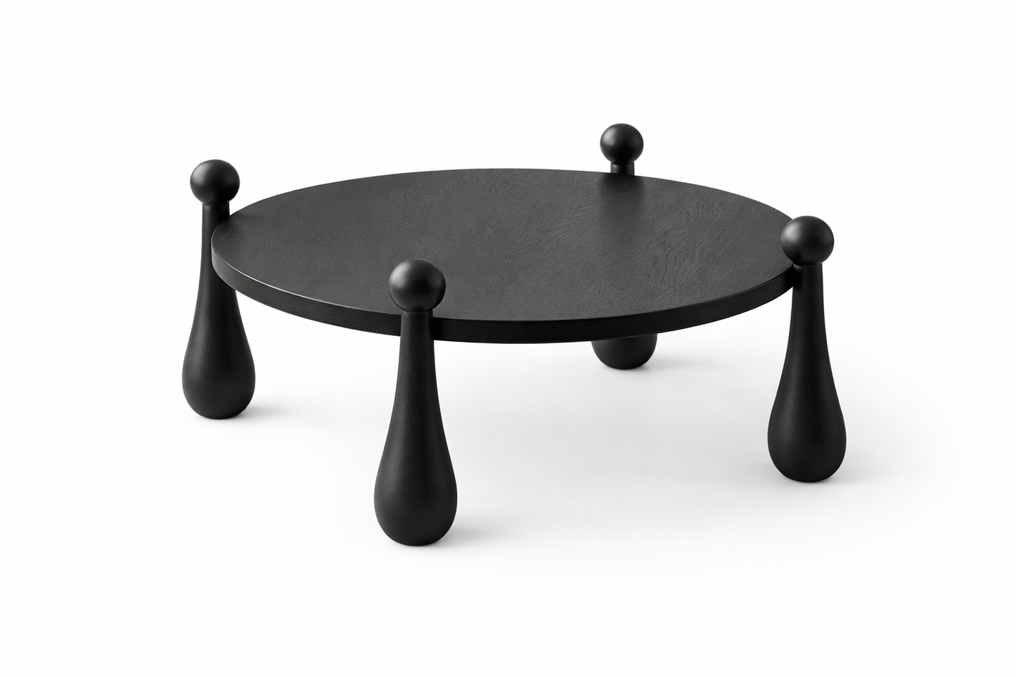 Black round table with unique legs on a white background