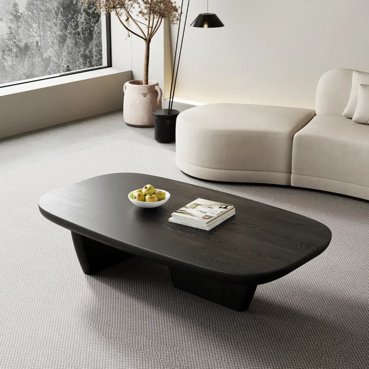Modern living room with a dark wooden coffee table, white sofa, and decorative elements.