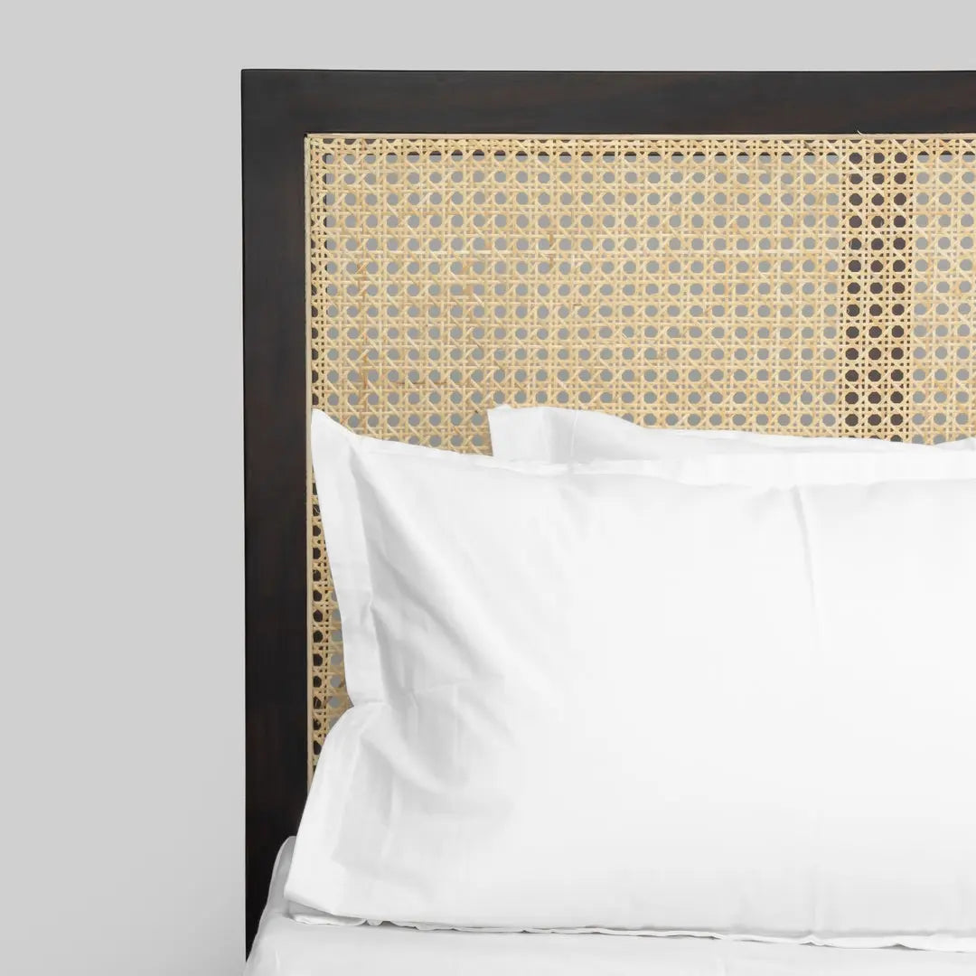 wooden bed with rattan headboard
