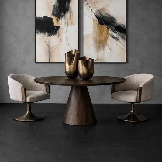 Modern interior with abstract art, round table, and chairs against a dark wall.