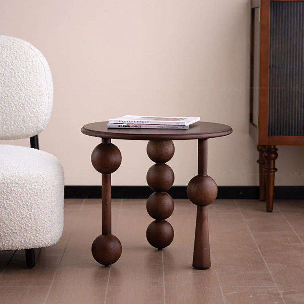 minimalist Small round table with spherical legs in a room setting
