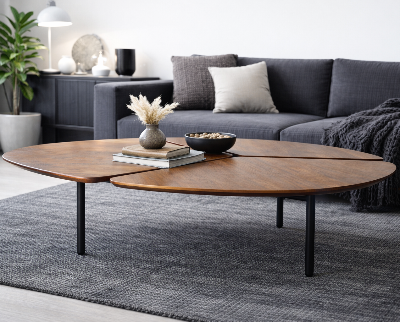 Modern living room with a gray sofa, wooden coffee table, and decorative items.