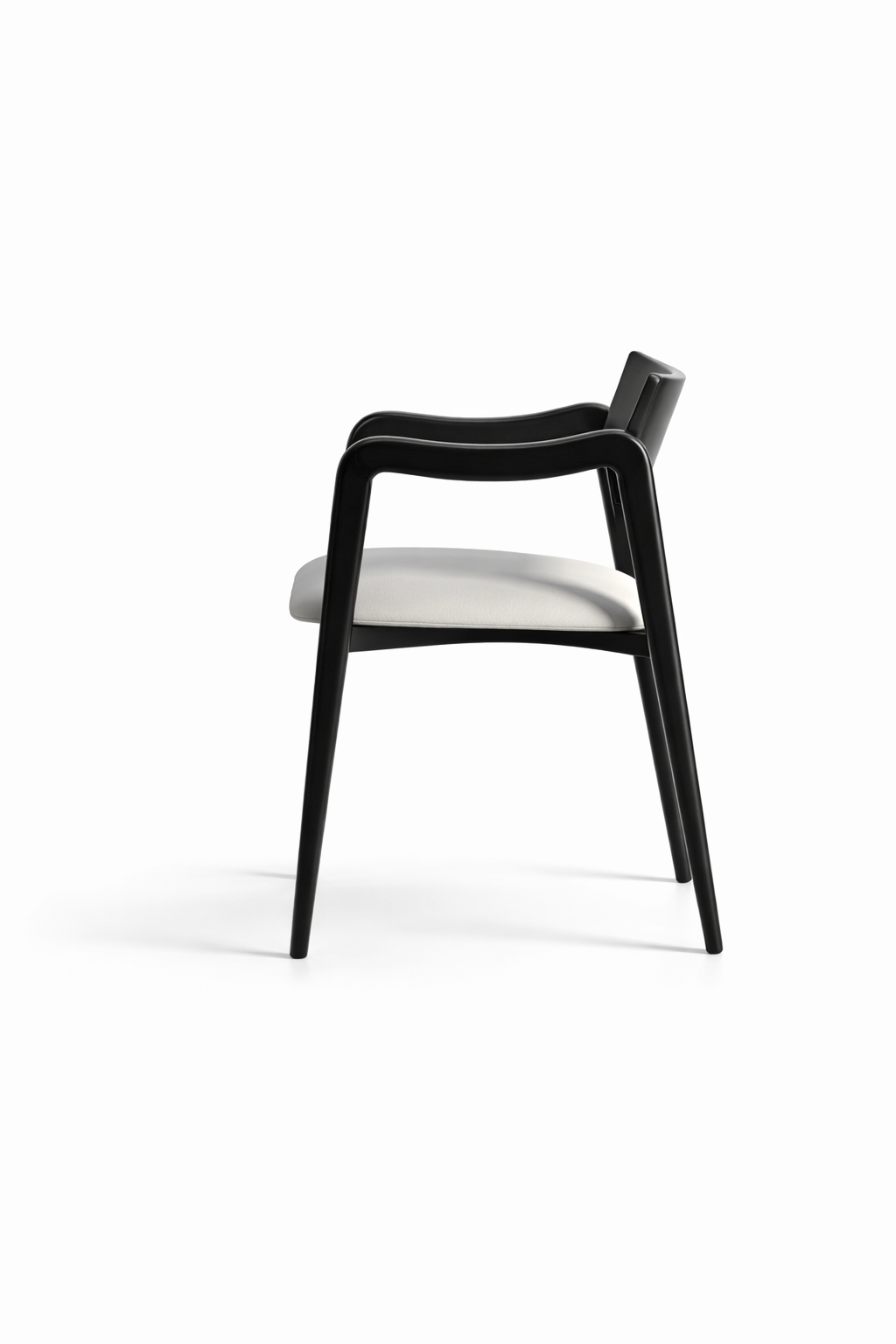 Black chair with a white cushion on a white background