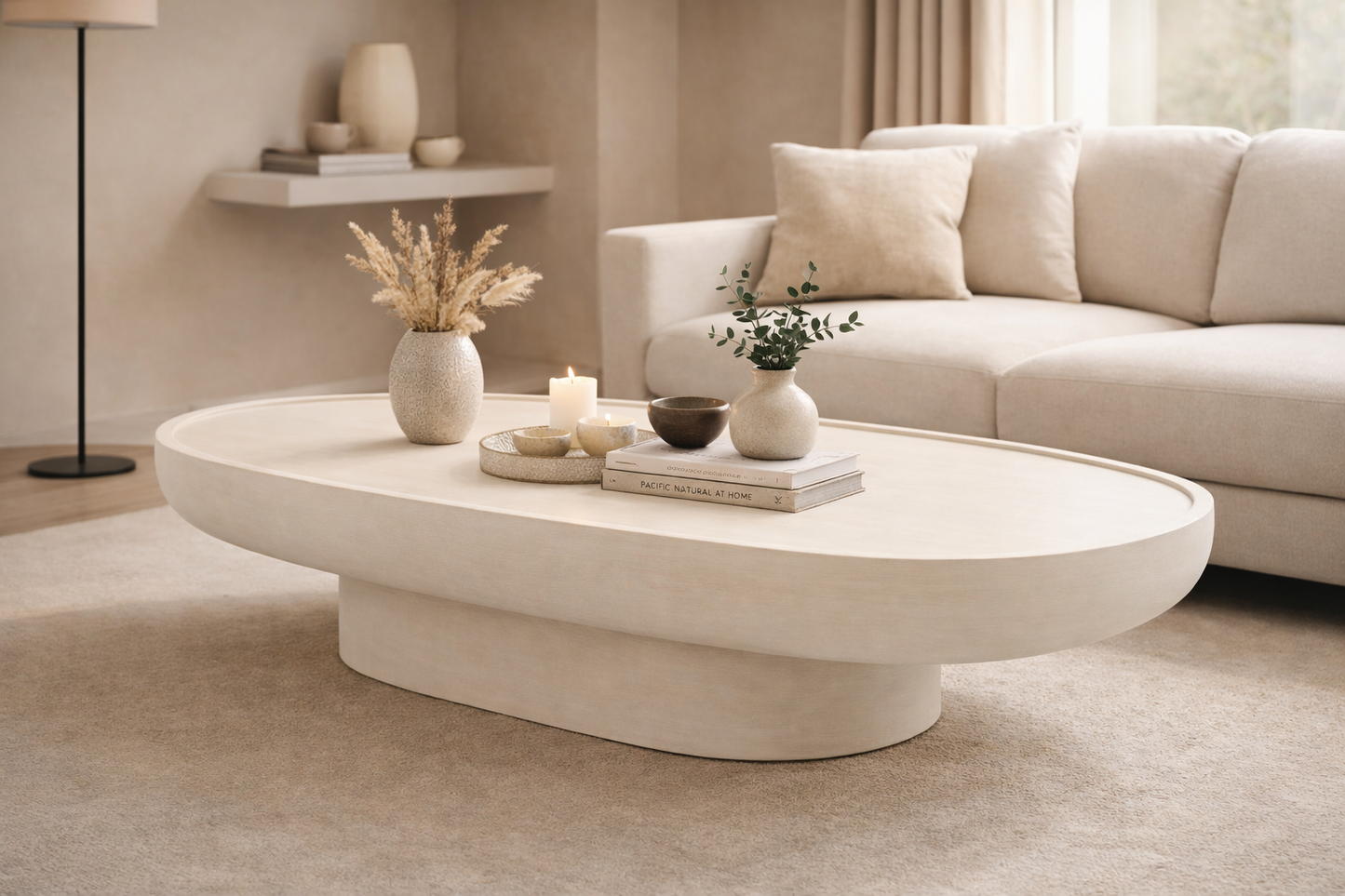 Modern living room with a beige sofa, coffee table, and decorative items.