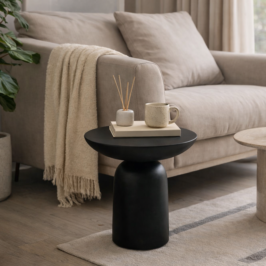 premium Living room with a beige sofa, black side table, and decorative items.