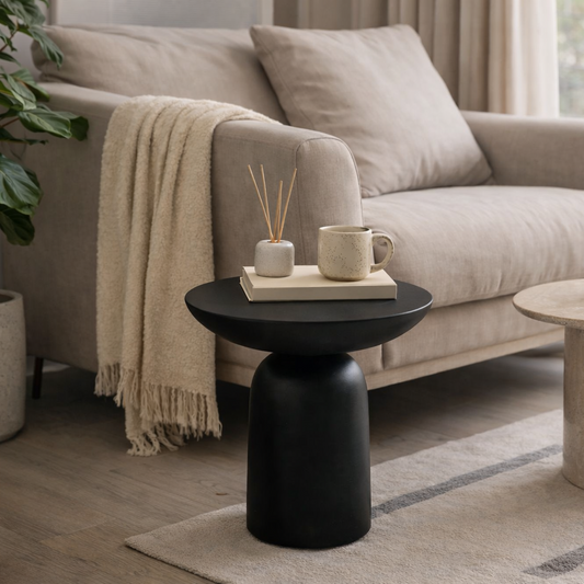 premium Living room with a beige sofa, black side table, and decorative items.