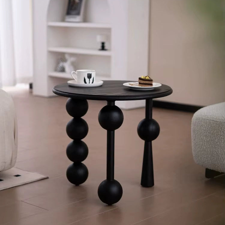 premium Modern black side table with spherical legs in a living room setting