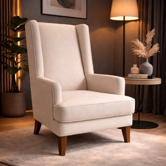 Beige armchair in a cozy living room setting with a lamp and decorative items.